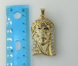 Golden-plated pendant of Jesus Christ in intricate design.
Large gold-plated pendant featuring a detailed Jesus Christ f