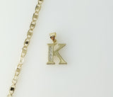 Gold plated mariner anchor chain necklace with a small letter K pendant.

Gold plated anchor chain necklace featuring a