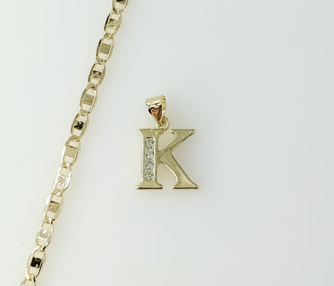 Gold plated mariner anchor chain necklace with a small letter K pendant.

Gold plated anchor chain necklace featuring a