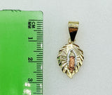 A delicate gold plated pendant featuring the Virgin Mary.

A stylized gold plated "M" pendant with a tri-color design.