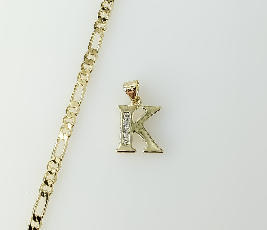 A delicate 3mm Figaro chain necklace with a small gold plated letter "K" pendant.