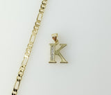 A delicate 3mm Figaro chain necklace with a small gold plated letter "K" pendant.