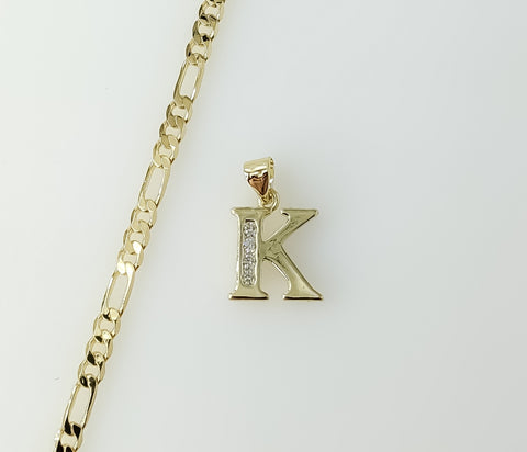 A delicate 3mm Figaro chain necklace with a small gold plated letter "K" pendant.