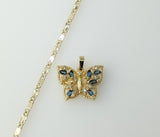 A gold plated dainty star shaped chain necklace with a butterfly design.