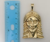 A gold-plated pendant featuring a detailed Jesus Christ silhouette.

A gold-plated pendant representing a stylized Jesus