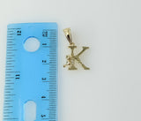 A delicate gold plated pendant featuring a stylized letter "K" symbol.
A small gold plated pendant in a star shape desig
