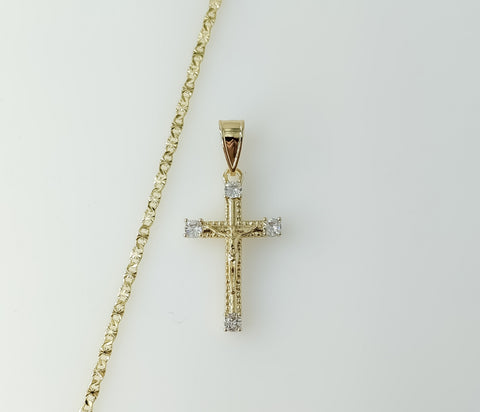 A delicate gold plated cross pendant on a small star chain necklace.