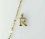 Dainty gold plated letter "R" star pendant on a chain necklace.