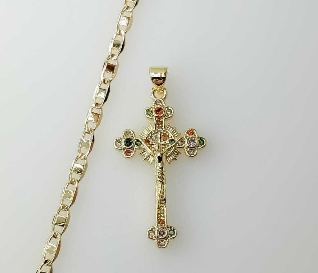A gold-plated flat chain necklace with a small Jesus crucifix pendant and anchor charm.
