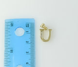 A small 3D star-shaped pendant with a stylized letter U design.
A tiny, ornate star pendant featuring a delicate letter