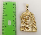 A gold-plated pendant of Jesus in a circular shape.
A gold-plated pendant featuring a symbol of Jesus.
A gold-plated pen