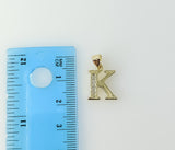 Gold plated pendant in the shape of a small letter K.
Gold plated pendant featuring a stylized letter K symbol.
Gold pla